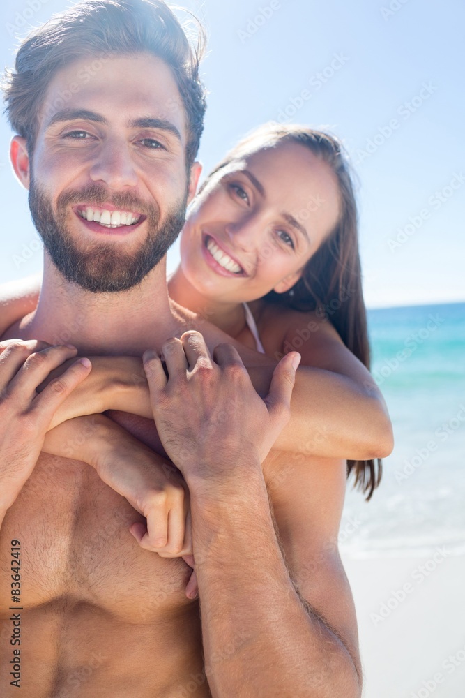 Fototapeta premium Happy couple hugging and looking at camera