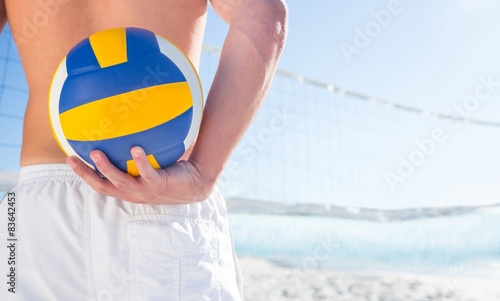 Handsome man holding volleyball