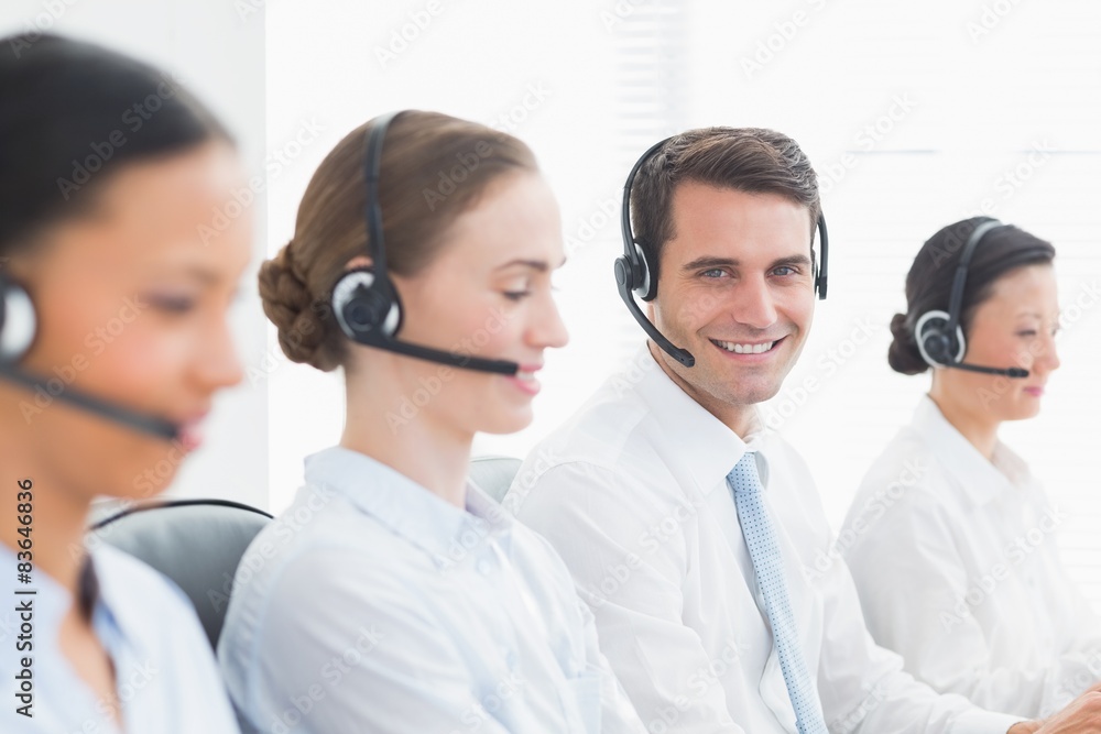 Business people with headsets using computers Business people with headsets using computers