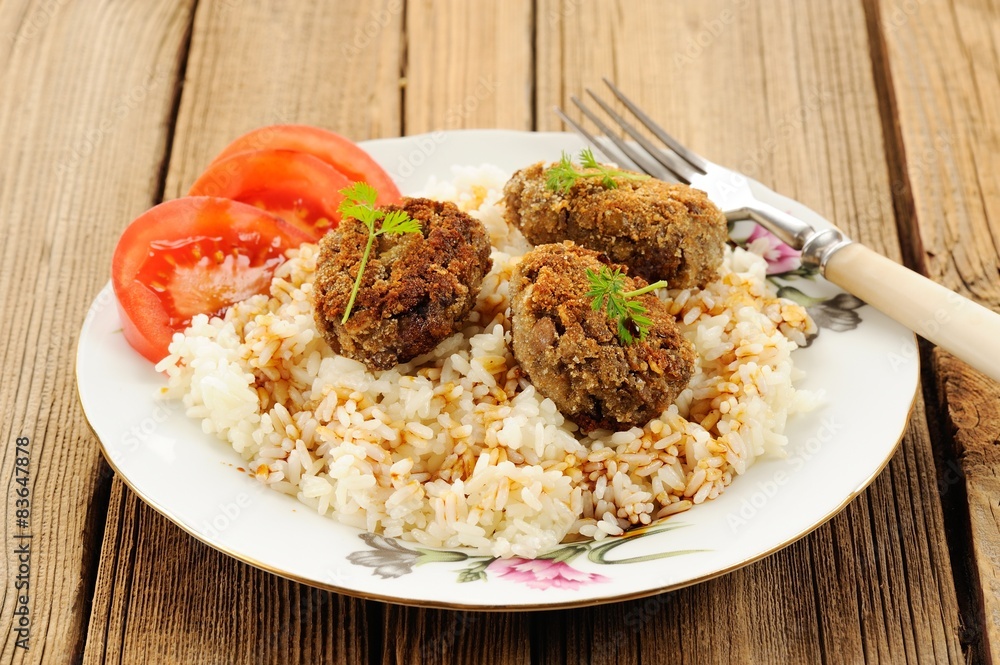 Three lentil patties with rice, tomato and microgreens in white Three lentil patties with rice, tomato and microgreens in white