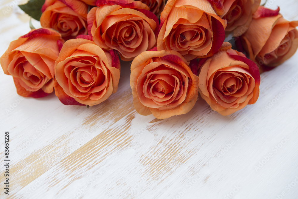 orange roses on white rustic wooden background orange roses on white rustic wooden background