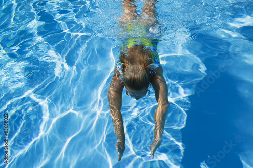 Swimmingpool, Frau schwimmt unter Wasser photo
