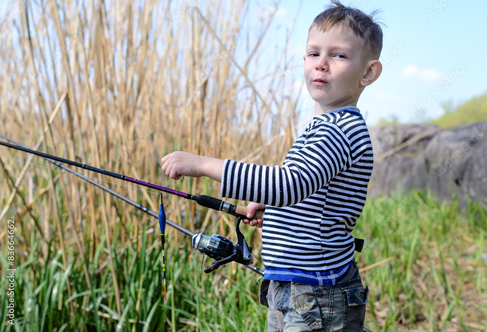 Handsome Young Kid Holding his Fishing Rod