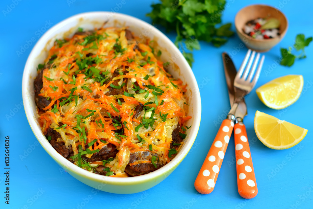 liver pancakes with onions and carrots in the baking dish liver pancakes with onions and carrots in the baking dish