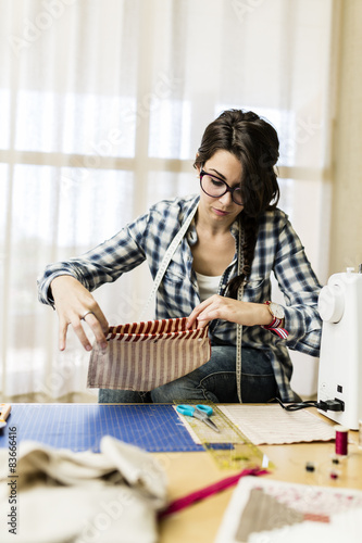 Young girl making hand bags and accessories at home