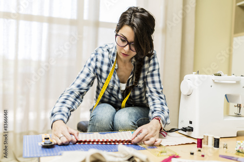 Young girl making hand bags and accessories at home
