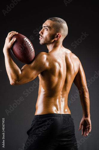 Muscular football player with ball © Elnur