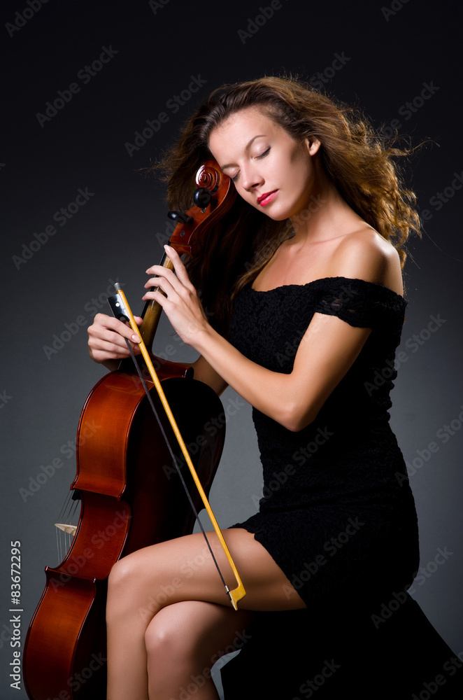 Female musical player against dark background Female musical player against dark background