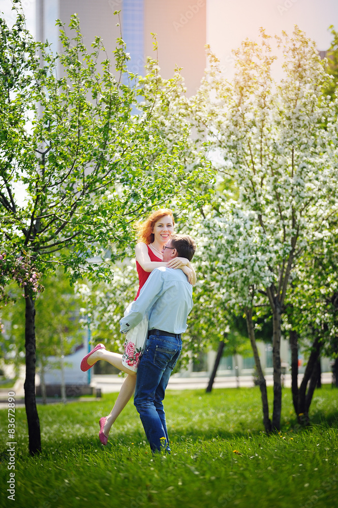 bride and groom walking in the blossoming spring garden bride and groom walking in the blossoming spring garden