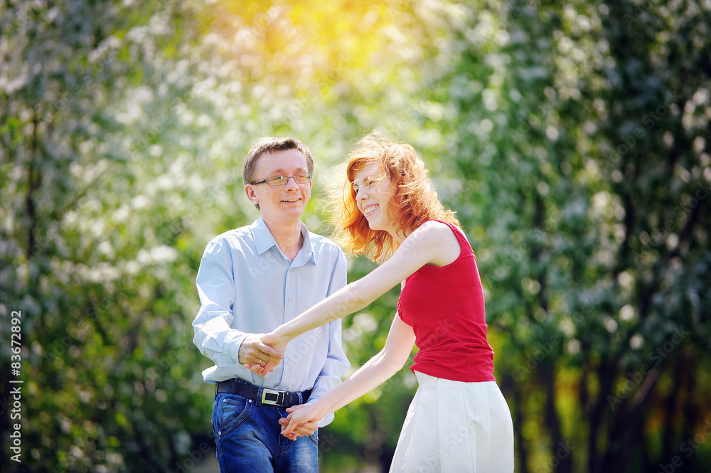 bride and groom walking in the blossoming spring garden bride and groom walking in the blossoming spring garden
