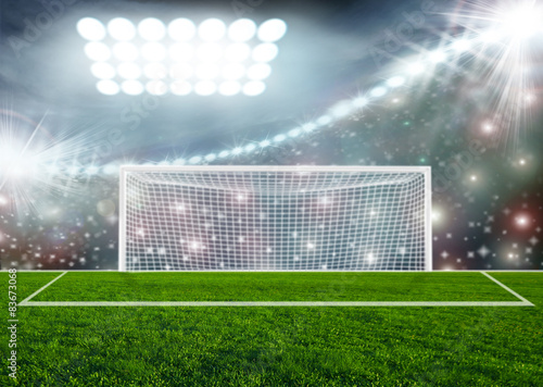 Soccer ball on green stadium arena