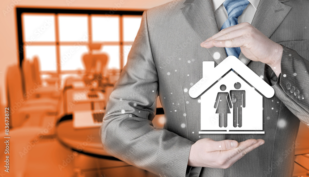 businessman protecting family in home with hands businessman protecting family in home with hands