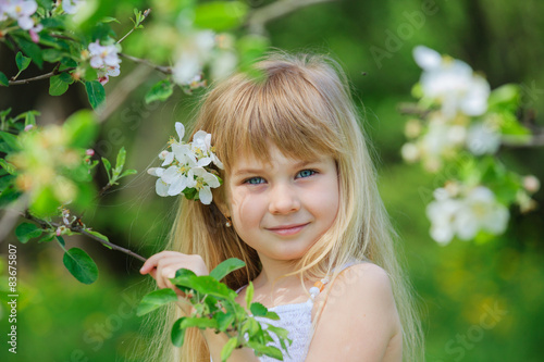 Girl in blooming apple tree garden