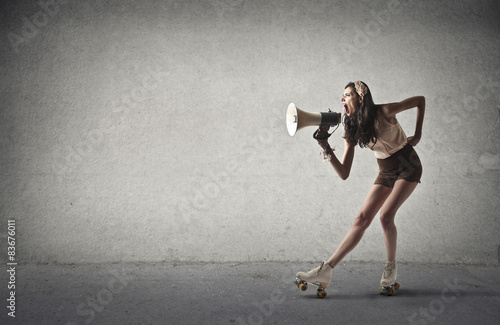 Girl yelling into a megaphone photo