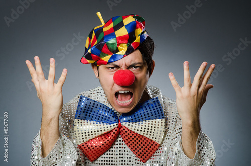 Funny clown against dark background