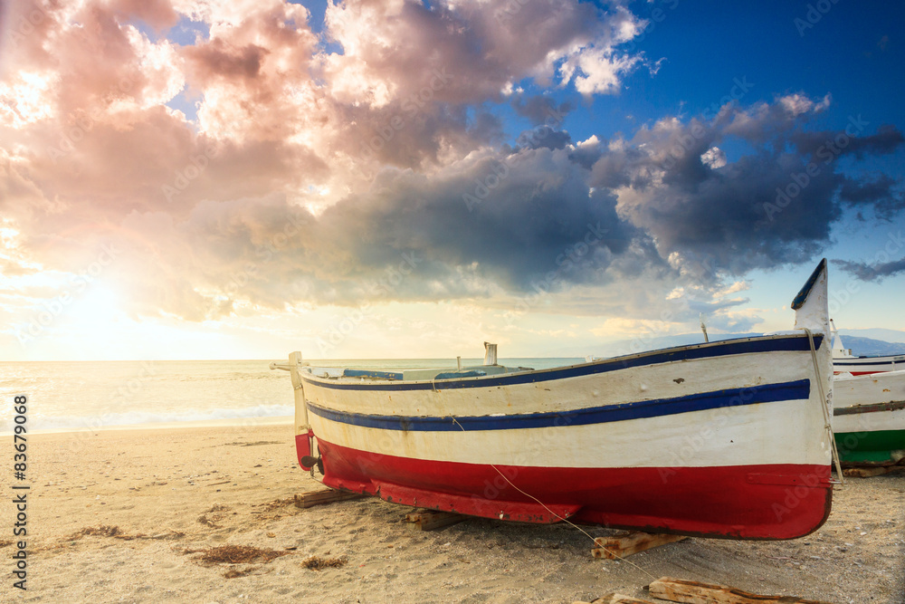 Boat on the beach at sunset time