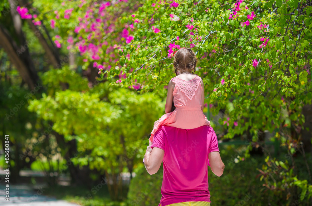 Little girl and young father during tropical beach vacation