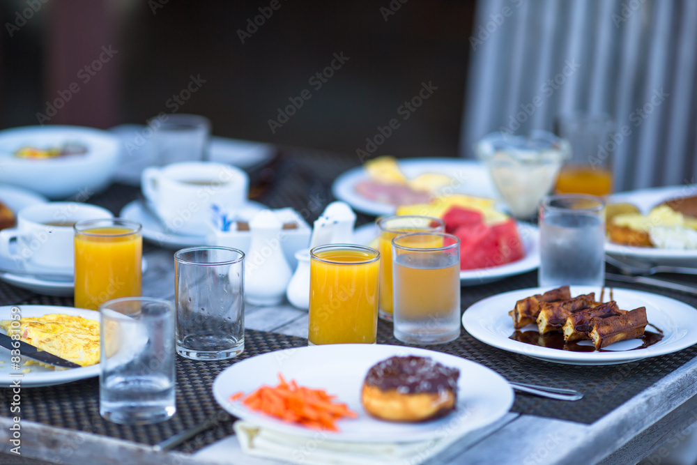 Delicious waffles, cake, coffee and juice served for breakfast Delicious waffles, cake, coffee and juice served for breakfast