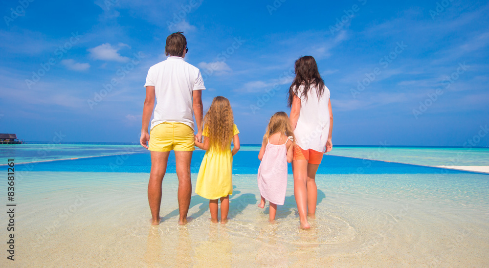 Beautiful family of four during summer tropical vacation Beautiful family of four during summer tropical vacation