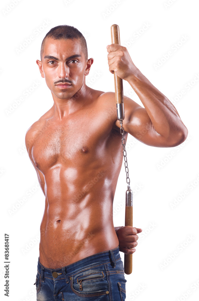 Young man with nunchucks isolated on white Young man with nunchucks isolated on white