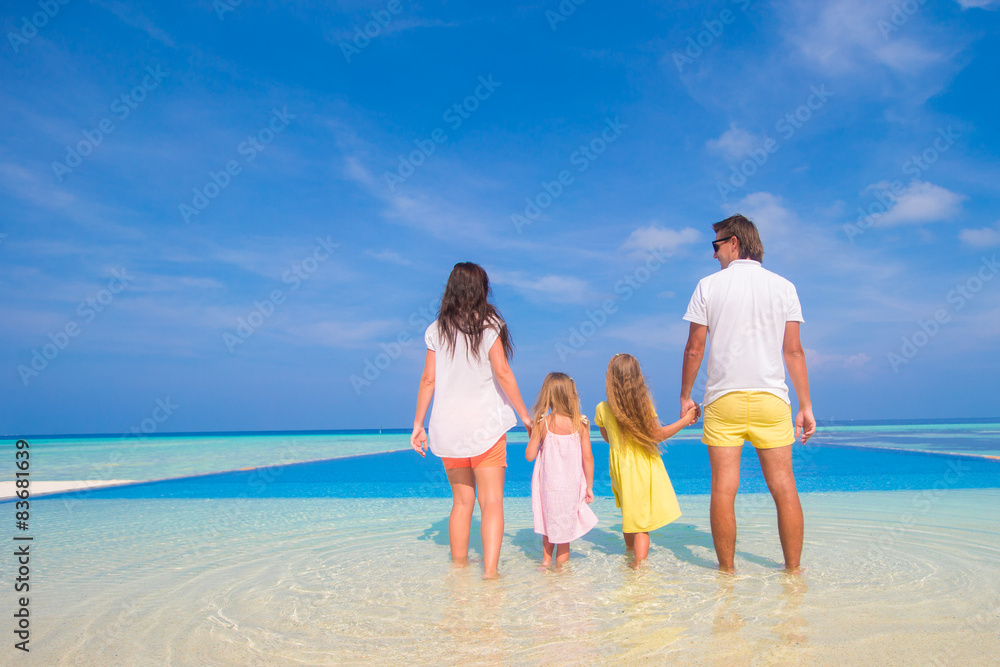 Beautiful family of four during summer tropical vacation