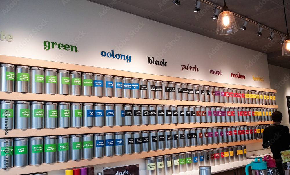 Store interior with bright tea containers on shelves