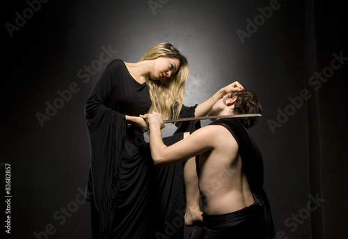 Fotografie Glamourous blonde lady and her slave is down on his knees