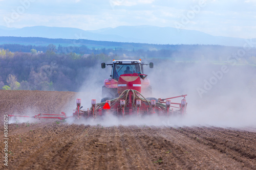 Tractor harrowing the field