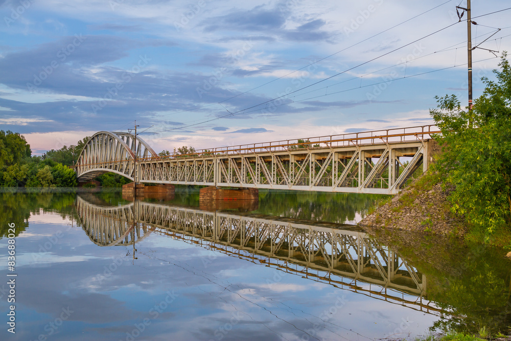 Train bridge over river with a nice sky scenery.
