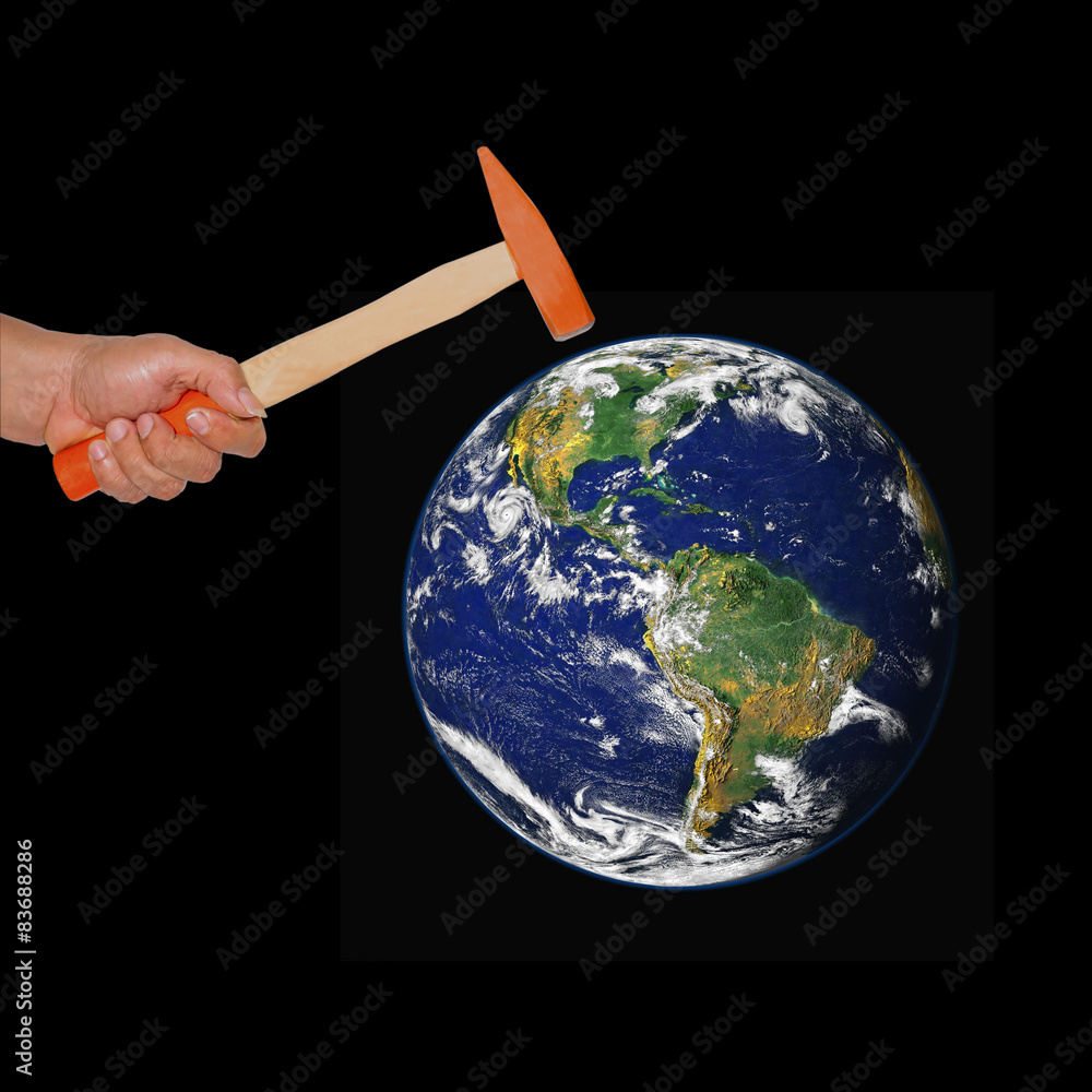 Hand hold a hammer hit the world .Elements of this image furnish Hand hold a hammer hit the world .Elements of this image furnish