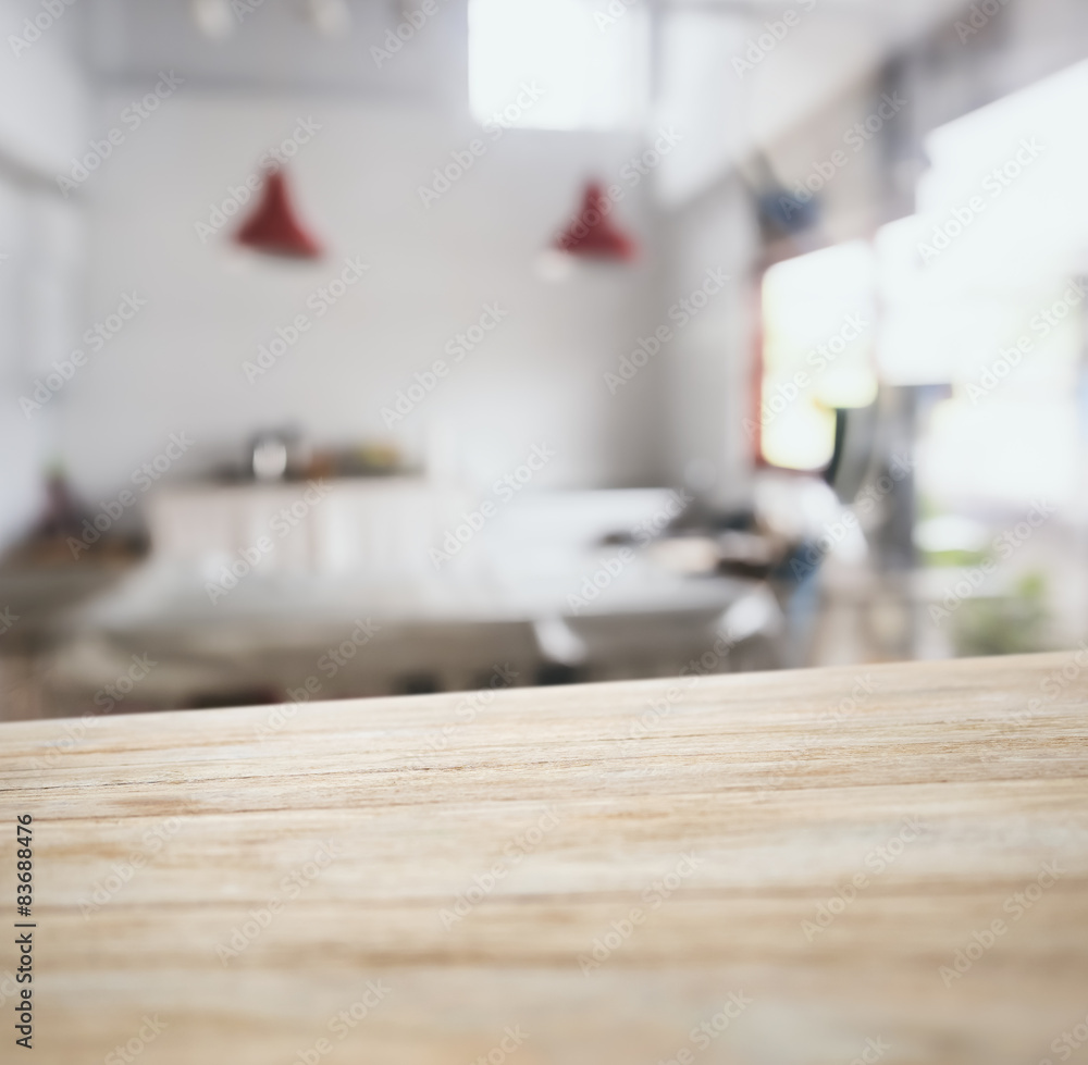 Wooden table top counter bar with blurred kitchen background Wooden table top counter bar with blurred kitchen background