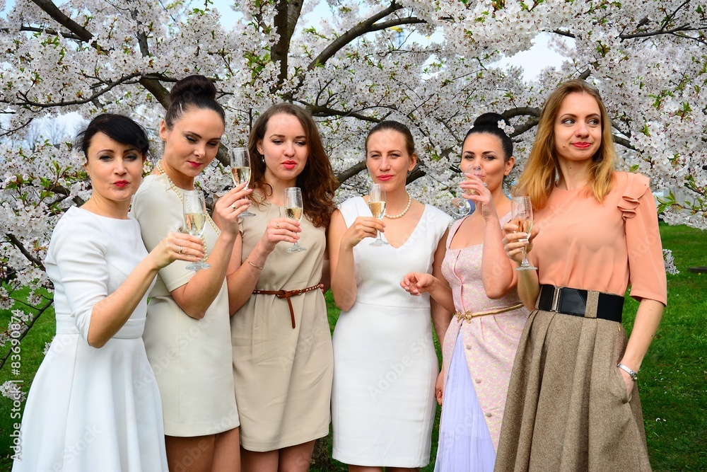 Girls with champagne celebrating in sakura's garden. Girls with champagne celebrating in sakura's garden.