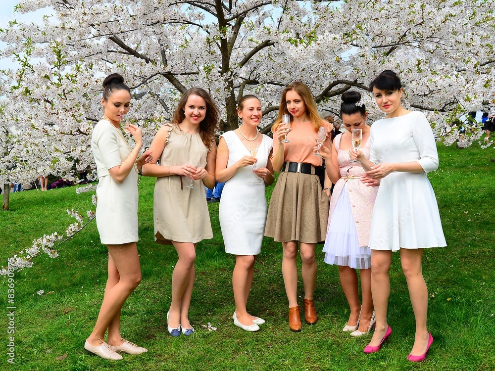 Girls with champagne celebrating in sakura's garden. Girls with champagne celebrating in sakura's garden.