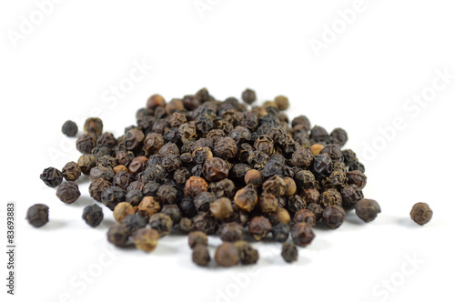 Foto Black peppercorn on white background