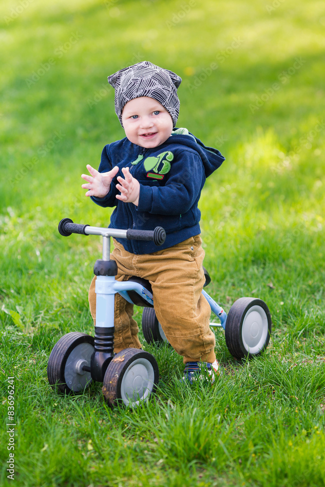 Cute baby boy on his first running bike Cute baby boy on his first running bike
