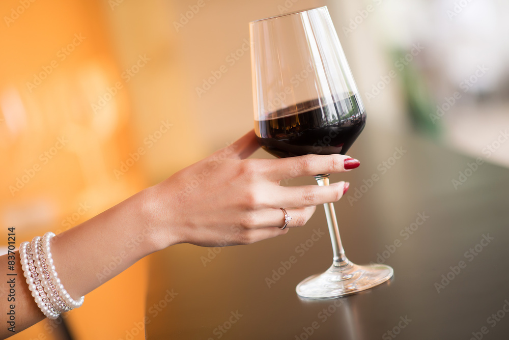 hand with a glass of wine