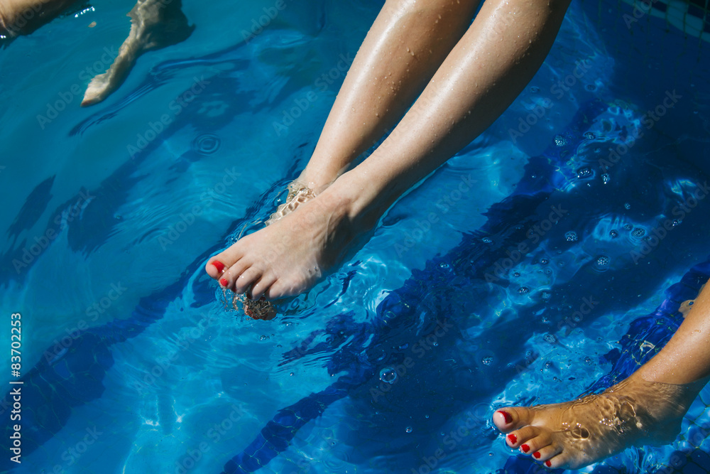 Legs of a women in swimming pool water