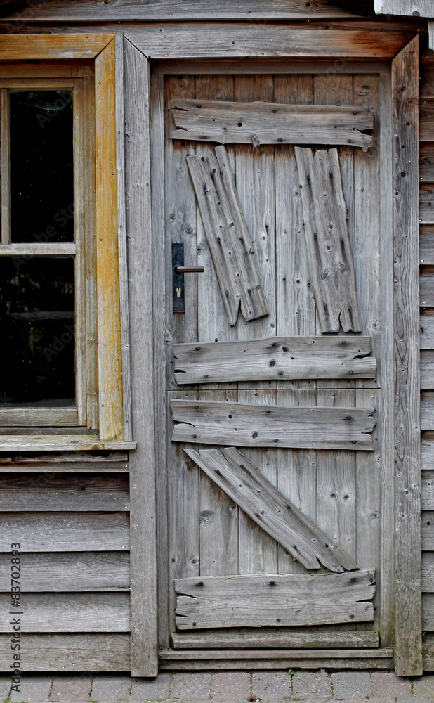 Obsolete wooden door of very old house Obsolete wooden door of very old house