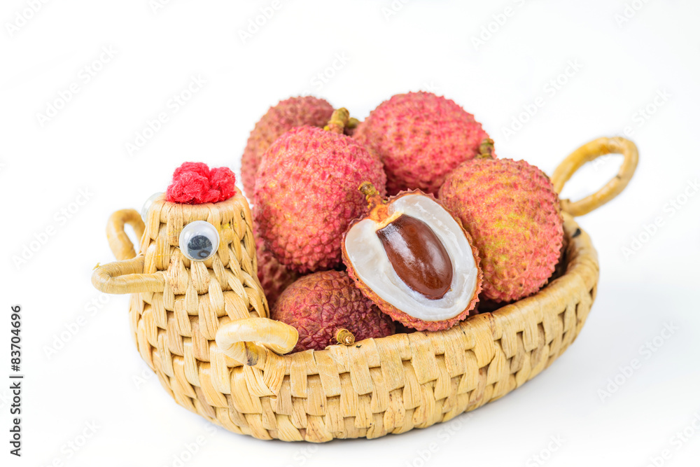 Ripe lychee fruit in hen basket against white background