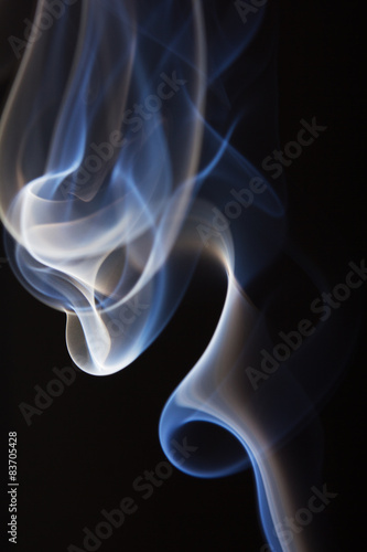 Abstract cigarette smoke on black background.
