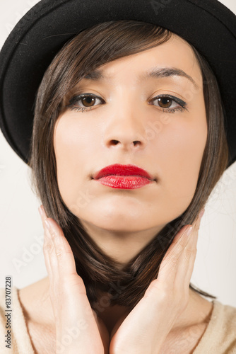 Portrait of a expressive beautiful girl with black hat