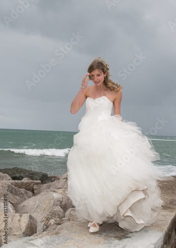 Bride standing close to the ocean waiting for her lover