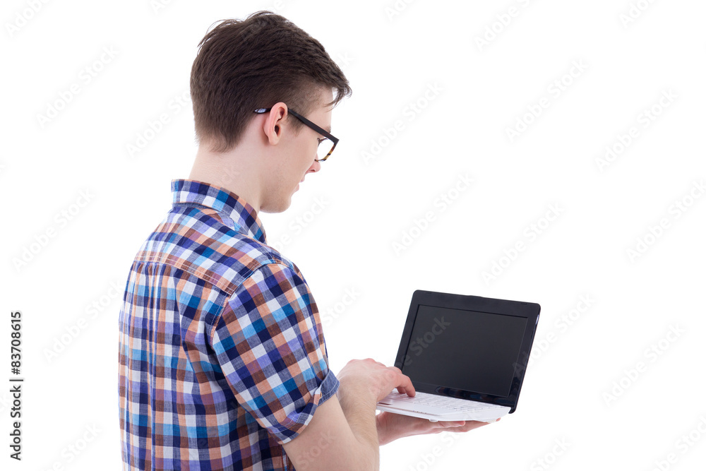 back view of handsome teenage boy holding laptop with blank scre back view of handsome teenage boy holding laptop with blank scre