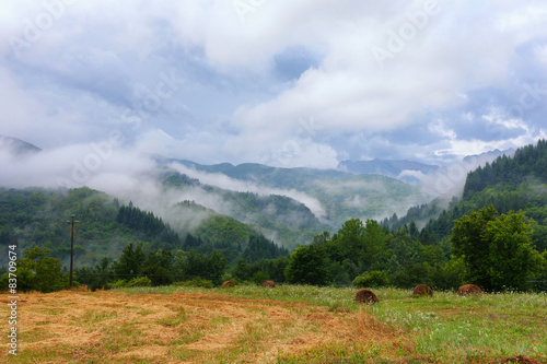 Hills with fog and clouds after rain in Tuscany