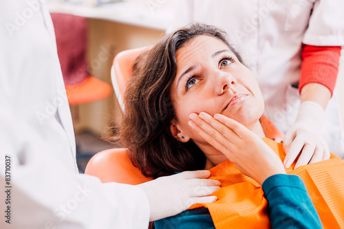 Woman with toothache at dentist photo