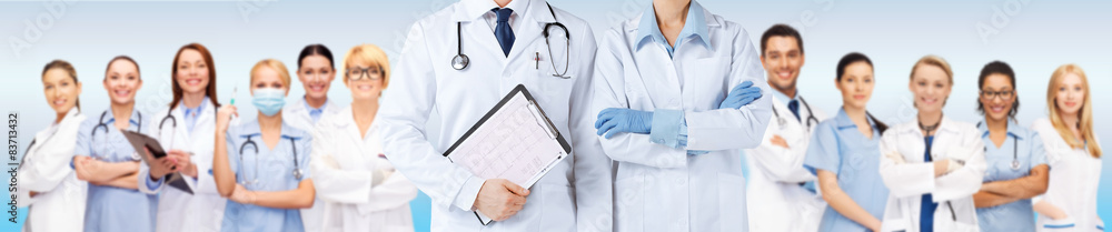 nurse and male doctor holding cardiogram - obrazy, fototapety, plakaty 