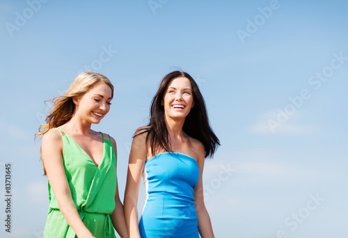 girls walking on the beach