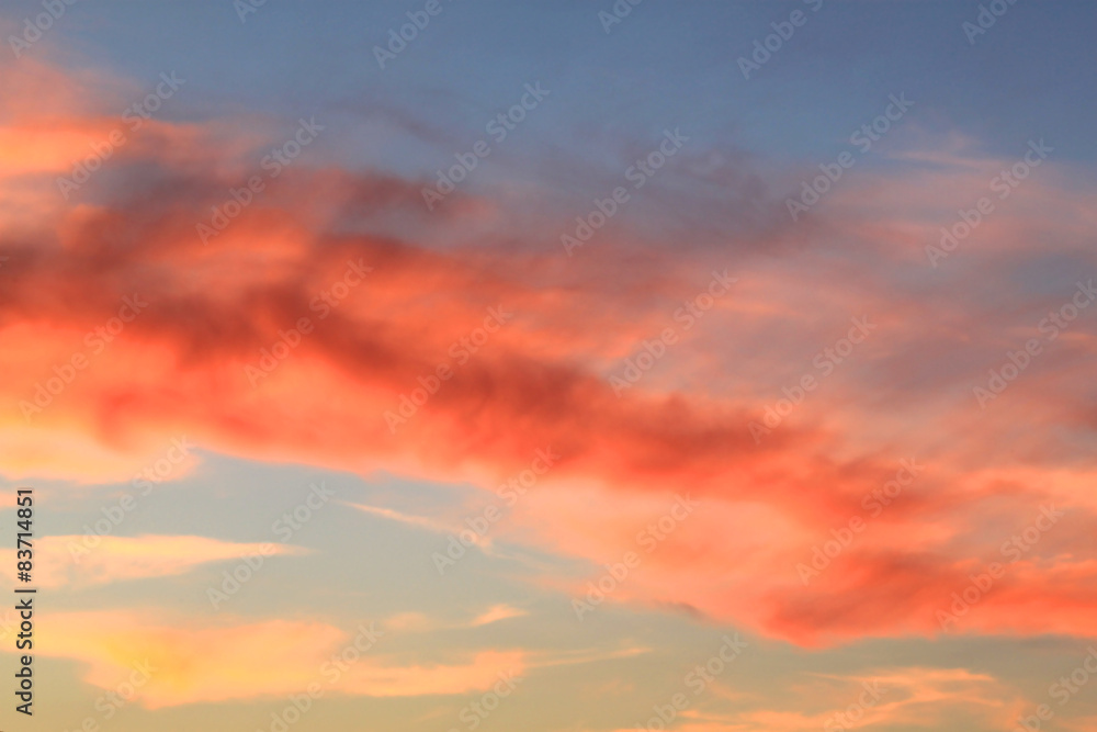 Sunset in the sky covered with red clouds