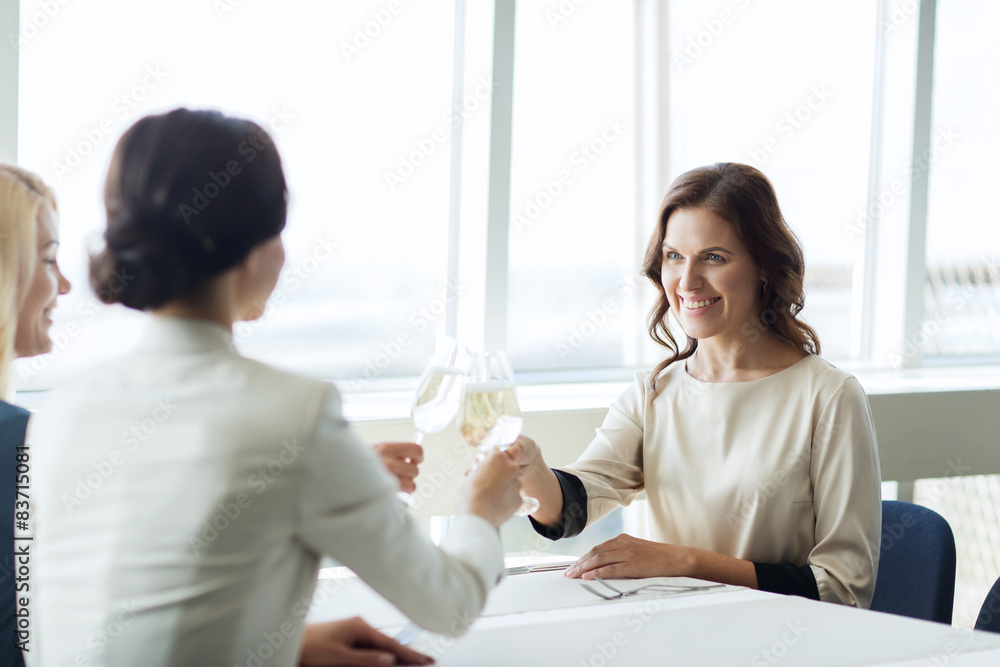 happy women drinking champagne at restaurant happy women drinking champagne at restaurant