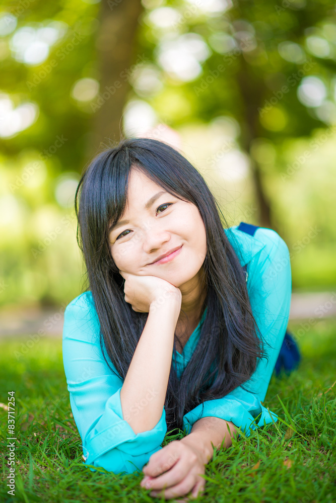 beautiful asian girl lying down on green grass beautiful asian girl lying down on green grass